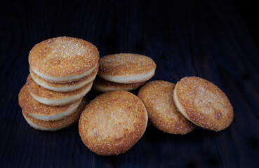 Beautiful round cookies on a black background. A few cookies. A bunch of cookies.