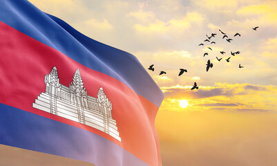 Waving flag of Cambodia against the background of a sunset or sunrise. Cambodia flag for Independence Day. The symbol of the state on wavy fabric. - obrazy, fototapety, plakaty