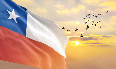 Waving flag of Chile against the background of a sunset or sunrise. Chile flag for Independence...