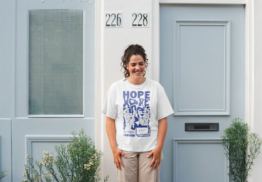 Mockup of woman wearing customizable t-shirt by front door