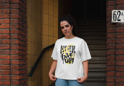 Mockup of woman wearing customizable t-shirt by apartment