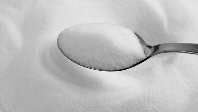Natural sweetener stevia measuring with teaspoon close up