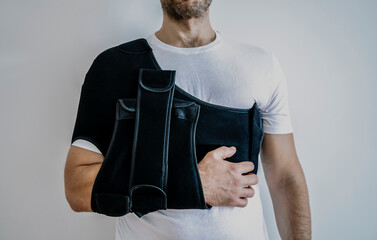 Shoulder orthosis orthoses orthopedic medical recovery sling for support hand background.