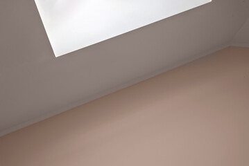 Minimalist geometric building interior detail, empty peach textured wall and attic ceiling with...