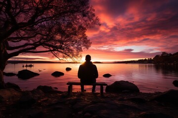 Fototapeta na wymiar Solitary man gazing at a breathtaking spring sunset by the seaside, Generative AI