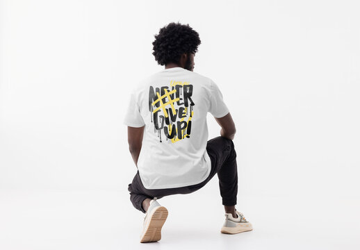 Mockup of man wearing customizable t-shirt and logo crouching