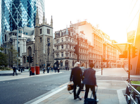 Business people walk in London financial district, England, UK