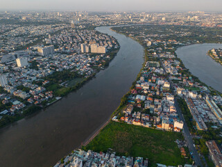 Panoramic view of Saigon, Vietnam from above at Ho Chi Minh City's central business district. Cityscape and many buildings, local houses, bridges, rivers