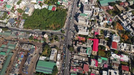 Aerial shot of a residential area in an Indian city. The houses are beautiful. An aerial view shows traffic on the roads of India.