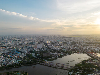 Panoramic view of Saigon, Vietnam from above at Ho Chi Minh City's central business district. Cityscape and many buildings, local houses, bridges, rivers