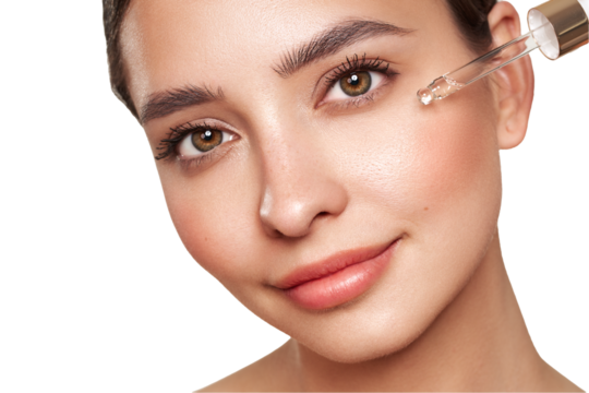 Young beautiful woman applying face serum with pipette. Cosmetic procedures for facial skin care