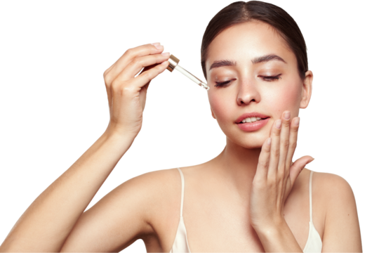 Young beautiful woman applying face serum with pipette. Cosmetic procedures for facial skin care