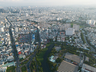 Naklejka premium Panoramic view of Saigon, Vietnam from above at Ho Chi Minh City's central business district. Cityscape and many buildings, local houses, bridges, rivers