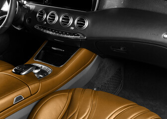 Car inside. Interior of prestige modern car. Comfortable brown leather seats. Perforated leather...