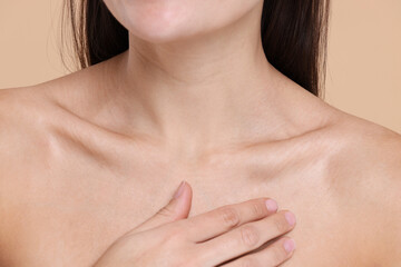 Closeup view of woman with healthy skin on beige background