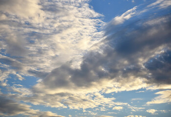 Cloudscape, Colored Clouds at Sunset near the Ocean in a Blue Sky