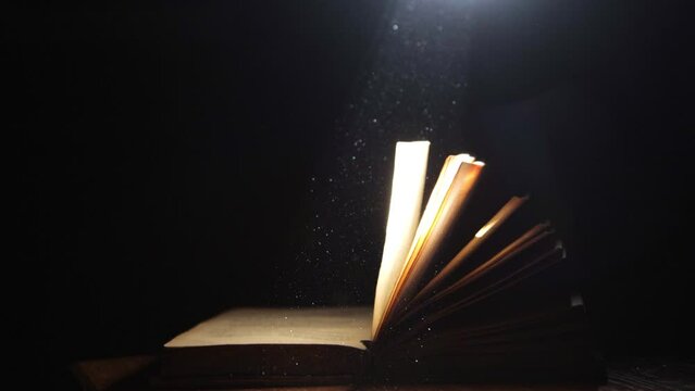 A ray of light falling on an old open book