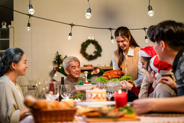 Asian lovely family celebrating Christmas party together in house. 