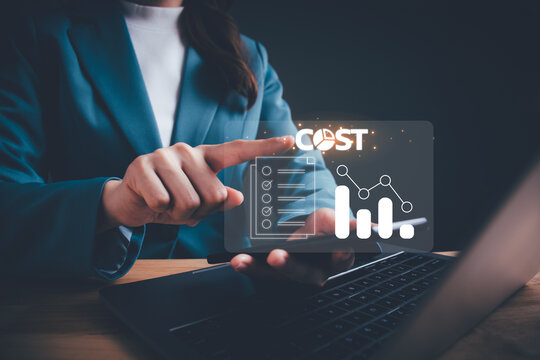 Businesswoman pointing down arrow of the graph with cost reduction business finance on virtual screen. Business, technology, cost management, cut budget, cost reduction concept.