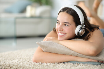 Happy woman listening music with headphone at home - obrazy, fototapety, plakaty