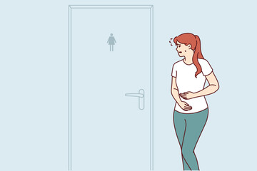 Woman suffering from diarrhea rushes to toilet standing near closed door due to stomach problems. Concept poor digestion causing diarrhea and need for help from gastroenterologist doctor - obrazy, fototapety, plakaty