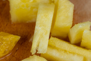 pieces of ripe pineapple sliced on a board