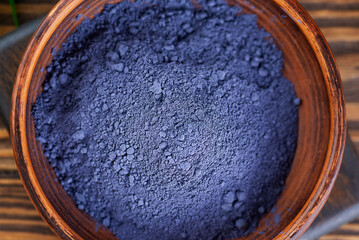Blue matcha powder from clitoria flowers in a bowl, closeup.