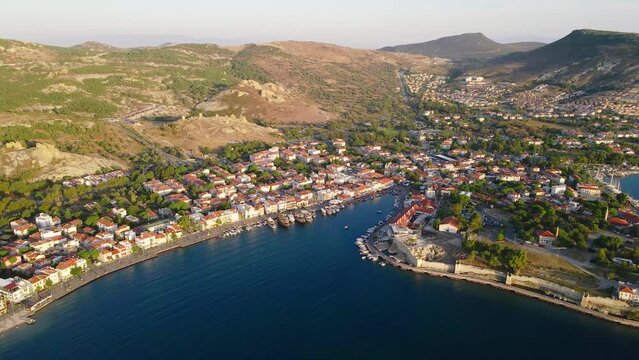 Aerial wide shot of Foca or Phokaia resort town with touristic street on sea bay, Izmir region Turkey