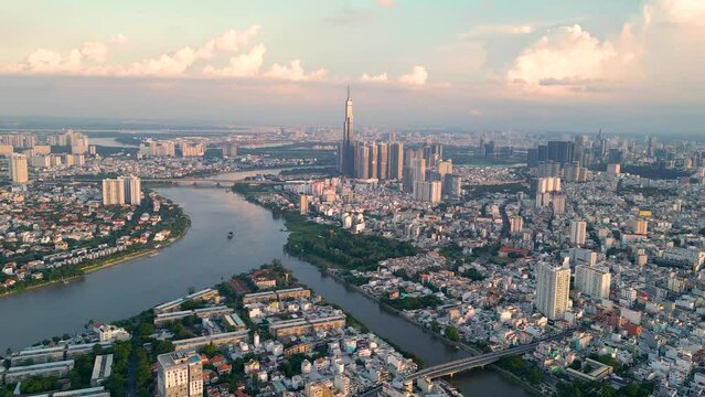 Panoramic view of Saigon, Vietnam from above at Ho Chi Minh City's central business district. Cityscape and many buildings, local houses, bridges, rivers