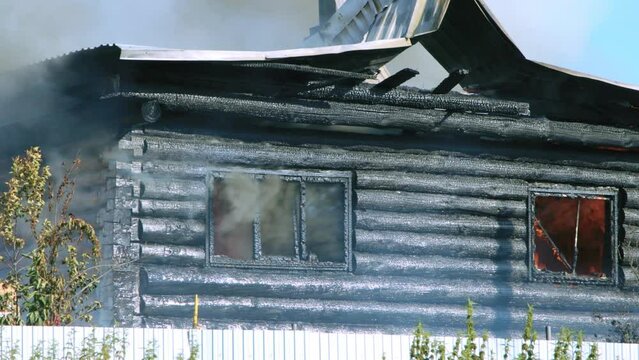 Firefighters extinguish a burning house