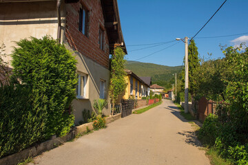 Fototapeta na wymiar A quiet residential road in Kulen Vakuf village in the Una National Park. Una-Sana Canton, Federation of Bosnia and Herzegovina. Early September