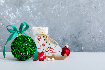 Christmas ball with skates on colored background. decoration bauble with ribbon bow with copy space