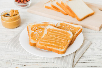 Peanut butter sandwiches or toasts on light table background.Breakfast. Vegetarian food. American cuisine top view vith copy space