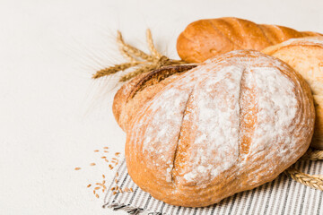 Homemade natural breads. Different kinds of fresh bread as background, perspective view with copy space