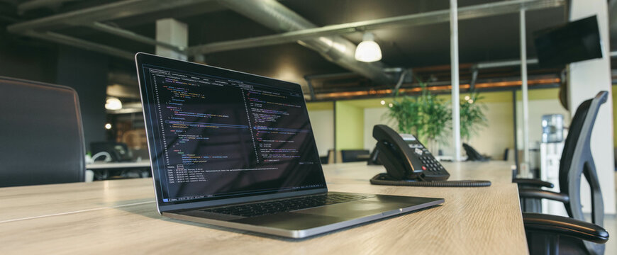 Productive work environment with coding and programming in a modern office