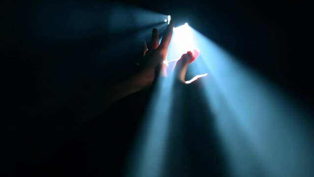 Child's hands reaching out to the light