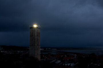 Lighthouse Brandaris on the Dutch island Terschelling by night under a cloudy sky