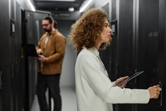 Young IT engineers working in server room