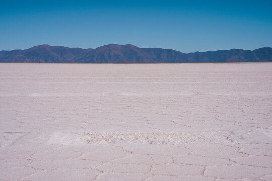 Salt flat near mountains under blue sky