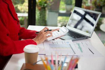 Business woman using a calculator to calculate personal income tax