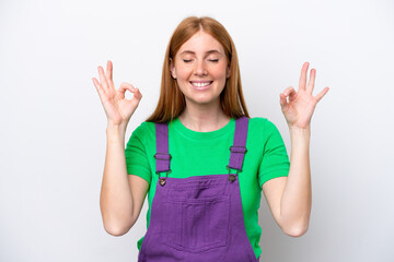 Fototapeta premium Young redhead woman isolated on white background in zen pose