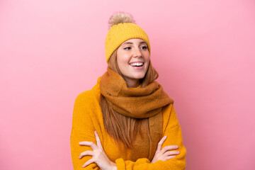 Young redhead woman wearing winter jacket isolated on pink background happy and smiling