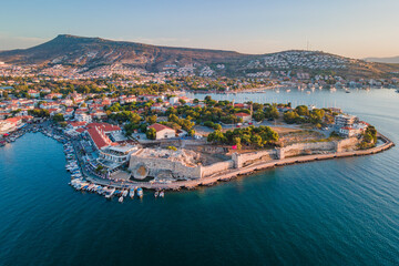 Ancient castle in Foca or Phokaia resort town in Izmir region at sunset, aerial view
