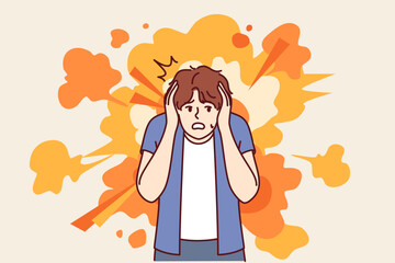 Frightened man gets scared by explosion and covers ears with hands to avoid stunning or concussion. Frightened guy stands near bright smoke, clutching head and afraid to turn back.
