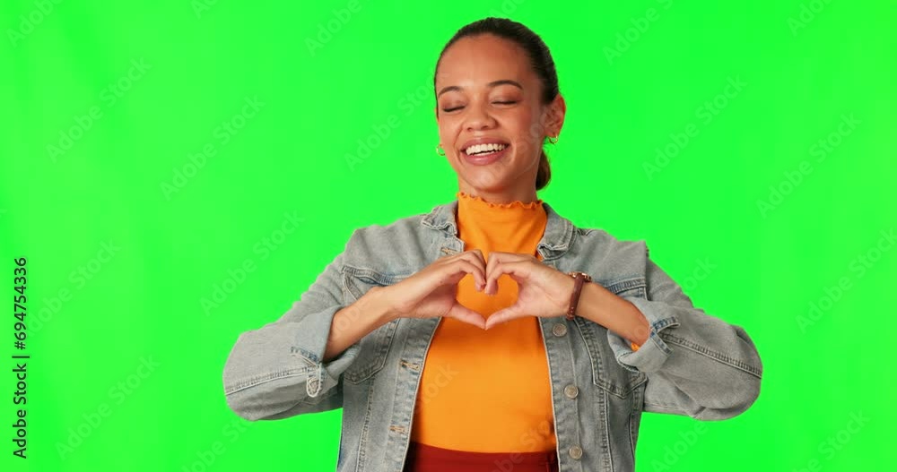 Canvas Prints Hands, heart shape and woman portrait on green screen for support, love and charity on studio background. Happy young person with hand emoji or icon for care, motivation and kindness with a smile