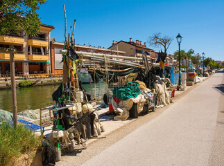 Fishing equipment lines a road on the waterfront of Grado in Friuli-Venezia Giulia, north east...