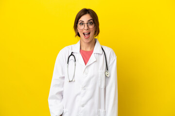 Fototapeta premium Doctor woman isolated on yellow background with surprise facial expression