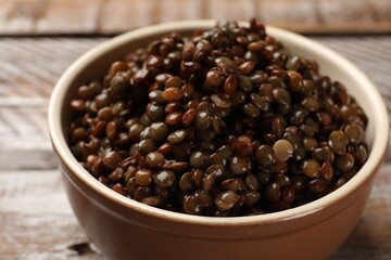 Delicious lentils in bowl on table, closeup