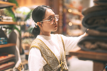 Asian stylish woman in vintage cloth shop purchase new fashion - obrazy, fototapety, plakaty