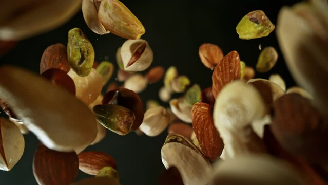 Super Slow Motion Closeup Shot of Falling and Rotating Various Nuts From Behind Camera at 1000fps.
